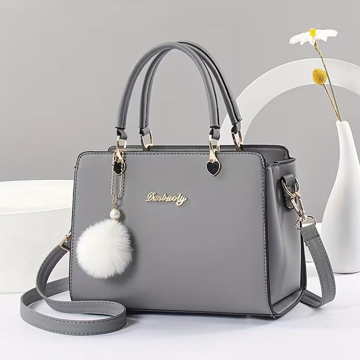 Sanika - Sac à Main Avec Breloque Pompon et Bandoulière
